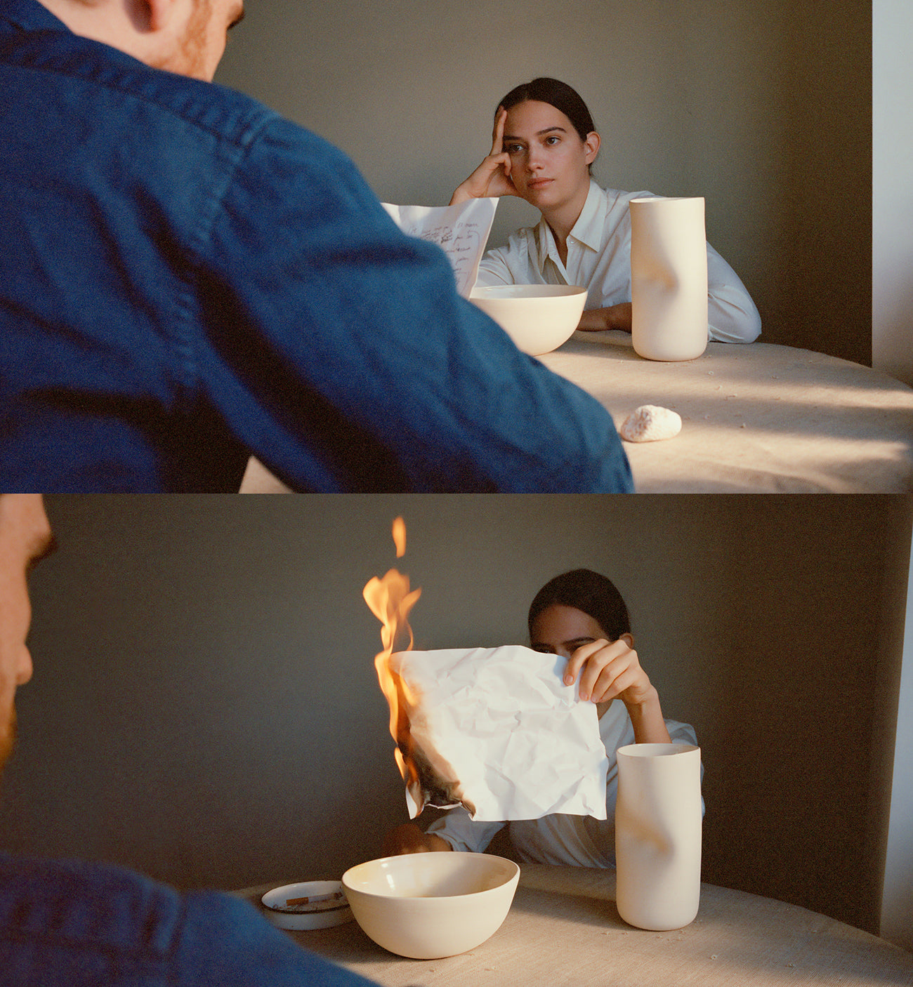 woman burning paper with hand-formed vase and bowl beside her